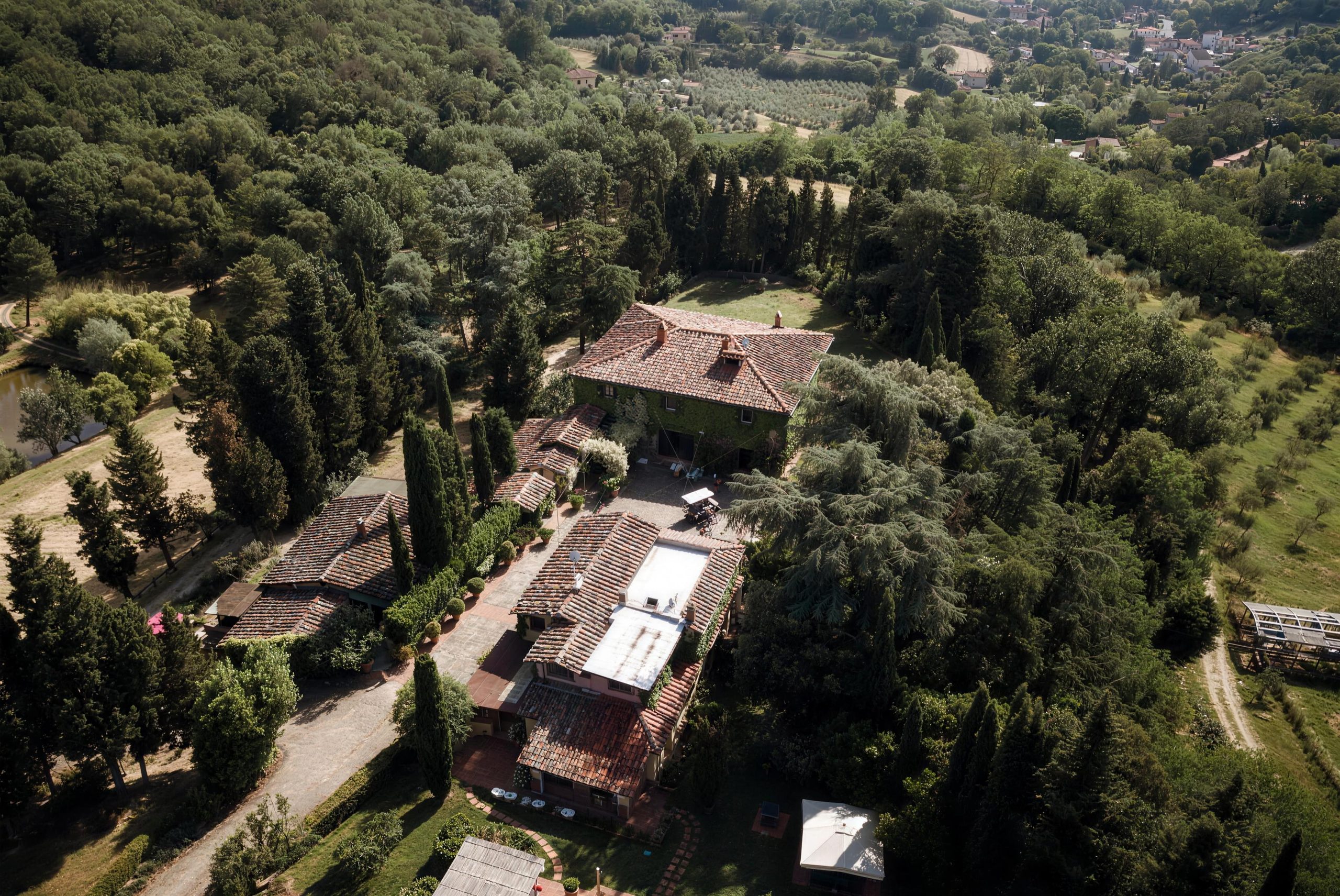 The villas of Podere La Specola from above, among the cypresses