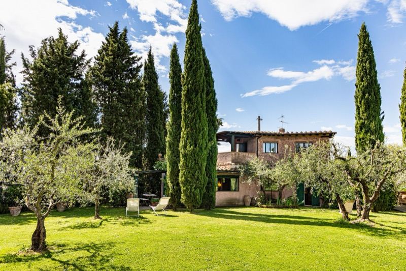 The villa among the cypresses seen from the lawn