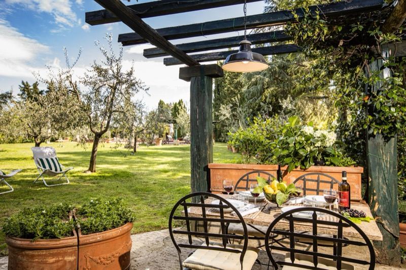The pergola with the table set overlooking the garden