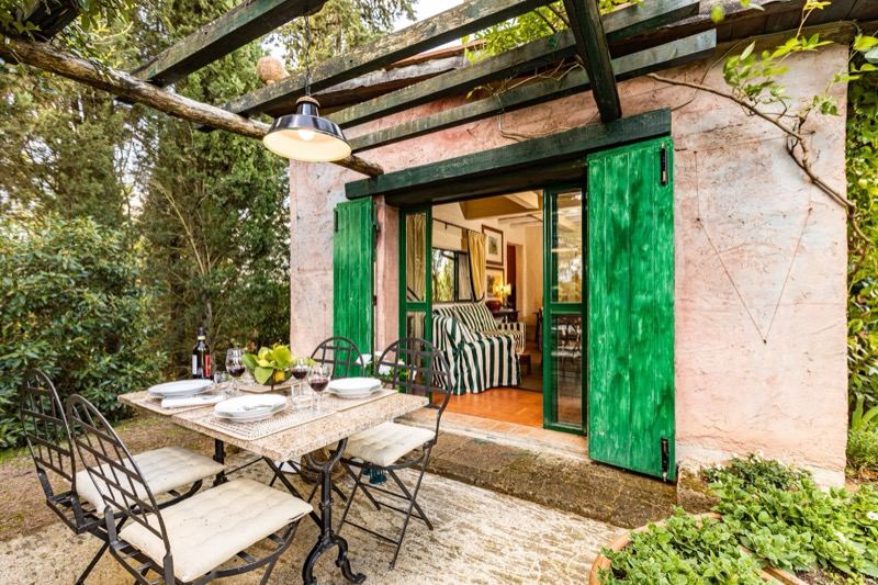The terrace table in front of the green doors