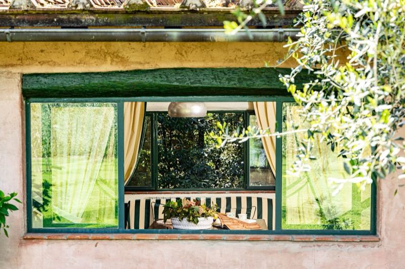 The green-framed window looking into the living room