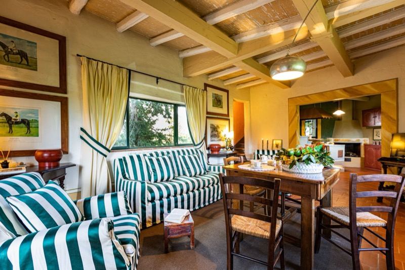 The living room with green striped sofas and horse prints