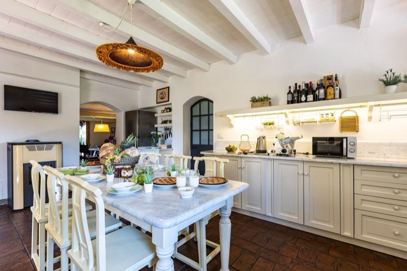 The kitchen with the table laid and the cabinets