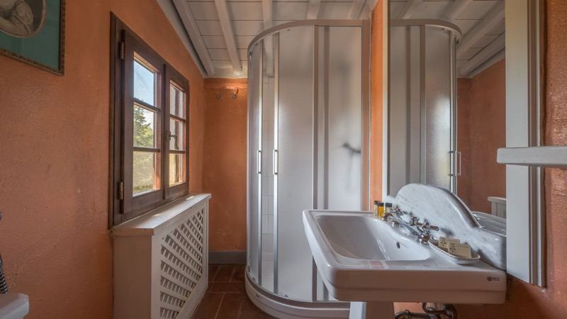The orange bathroom with shower and basin