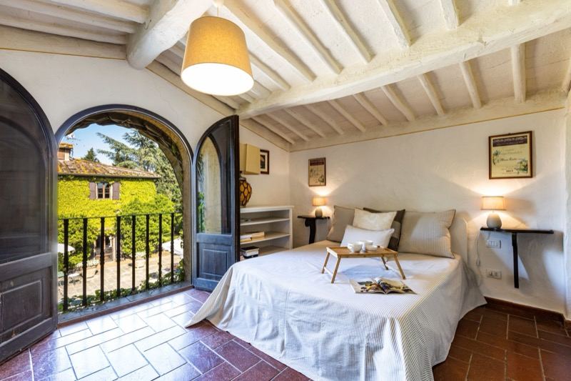 Bedroom with the arched door open onto the balcony