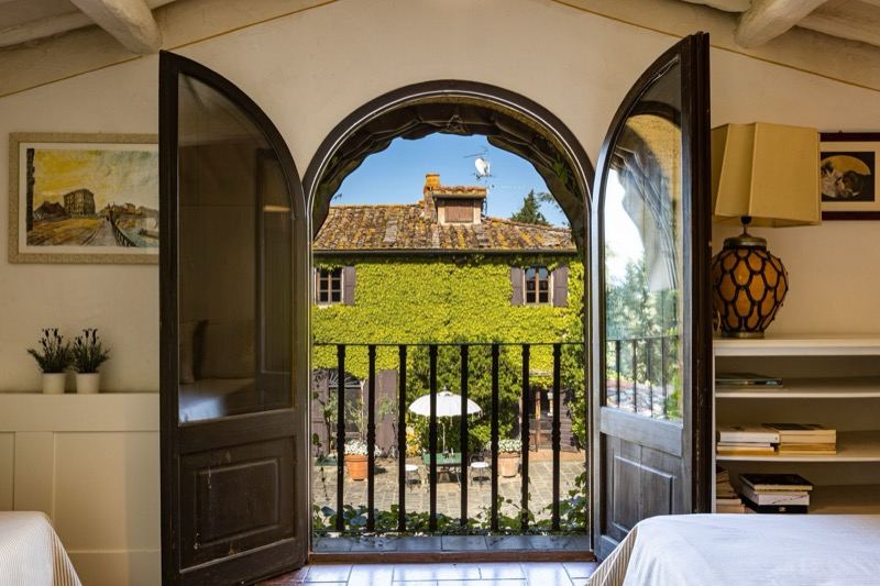 Bedroom with an arched door and balcony over the courtyard