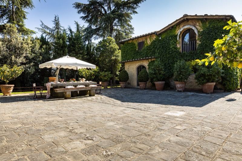 The stone courtyard with a table under the parasol