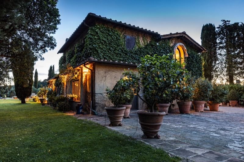 Il Fienile at dusk, with potted lemon trees