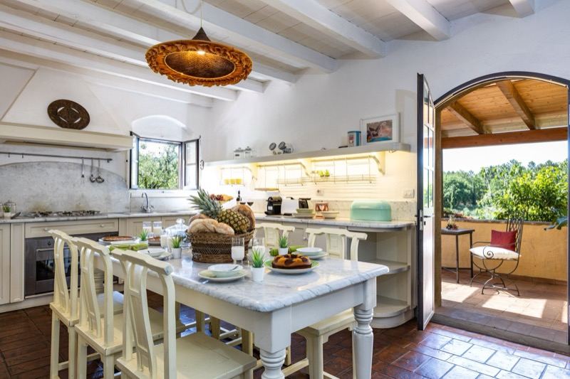 The white kitchen with marble table and door to the garden