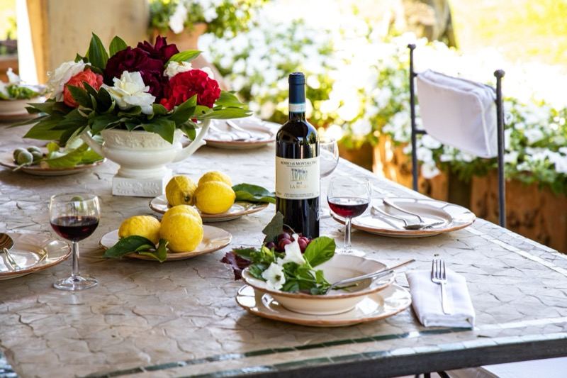 Table set outdoors with wine and lemons