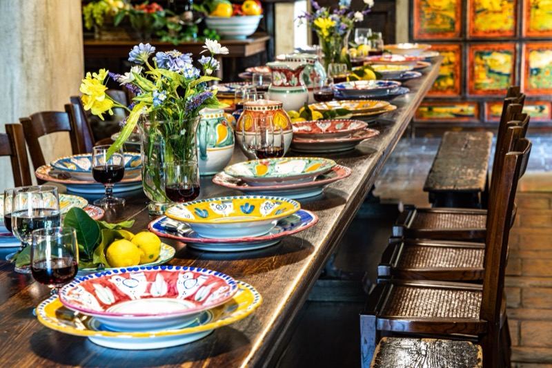 The long kitchen table laid with ceramics