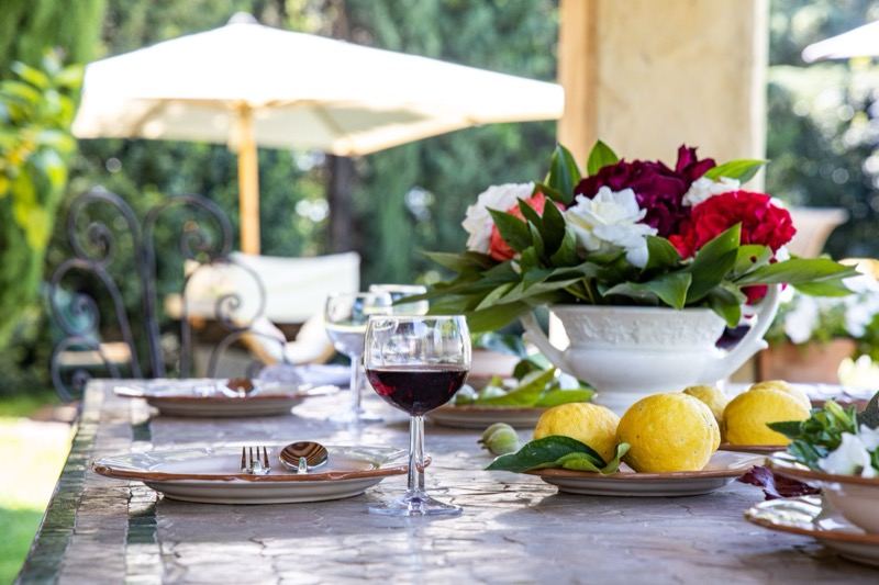 Table with flowers and wine under the parasol