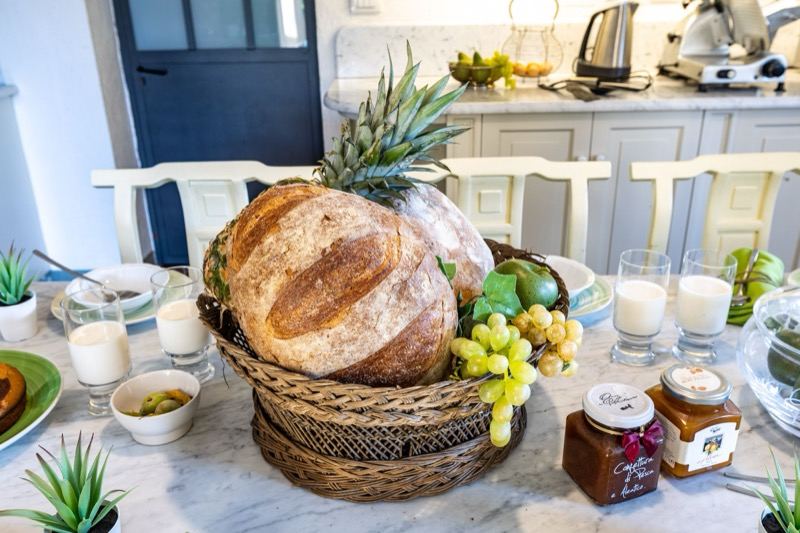 Bread, grapes and jams on the kitchen table