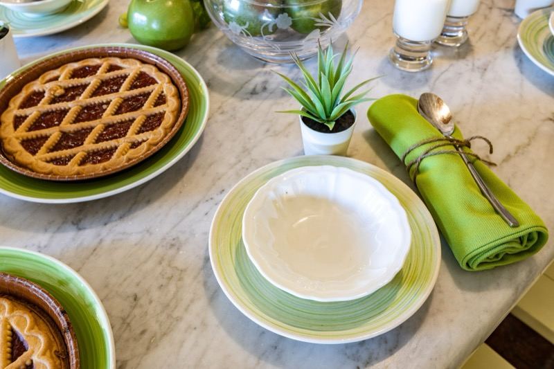Jam tart and green plates on the marble table