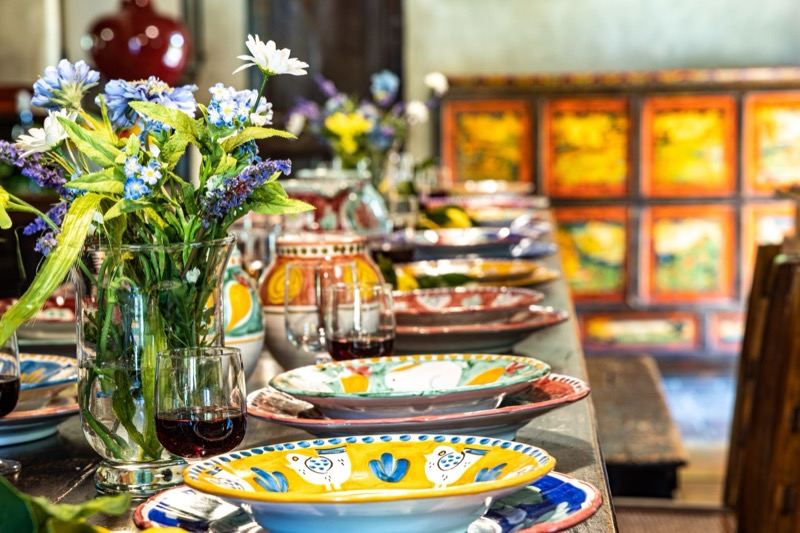 Painted ceramics and wildflowers on the long table