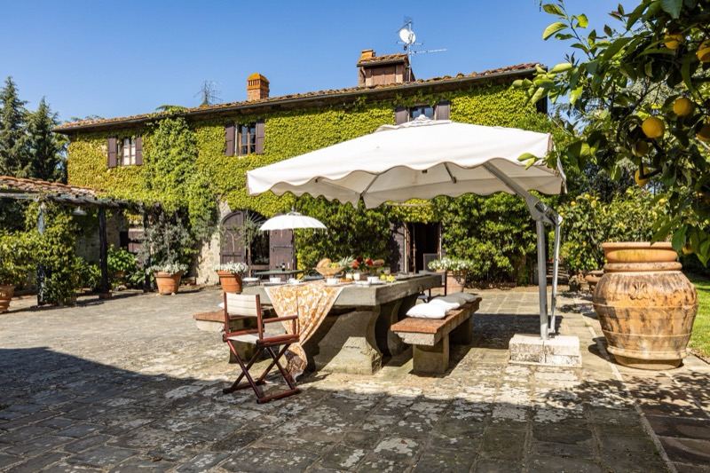 The courtyard with the table under the parasol