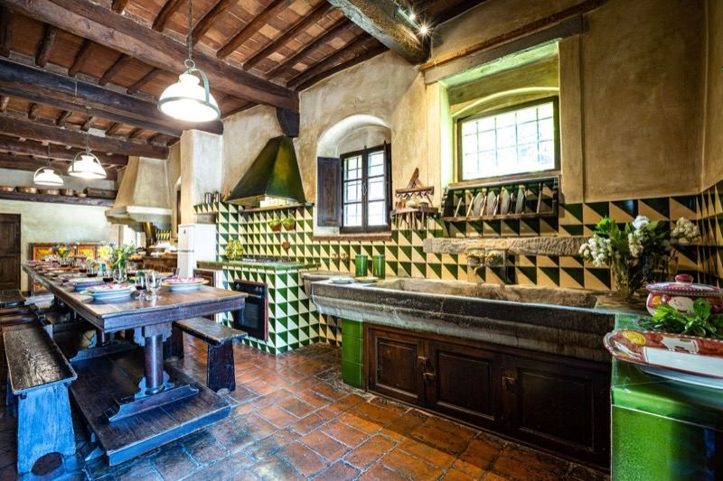 The large kitchen with the wooden table and benches