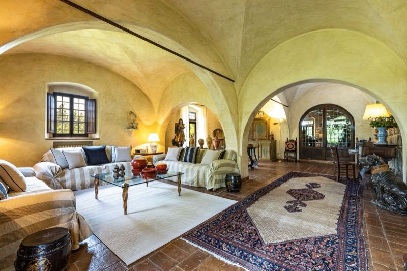 The vaulted living room with striped sofas and rugs