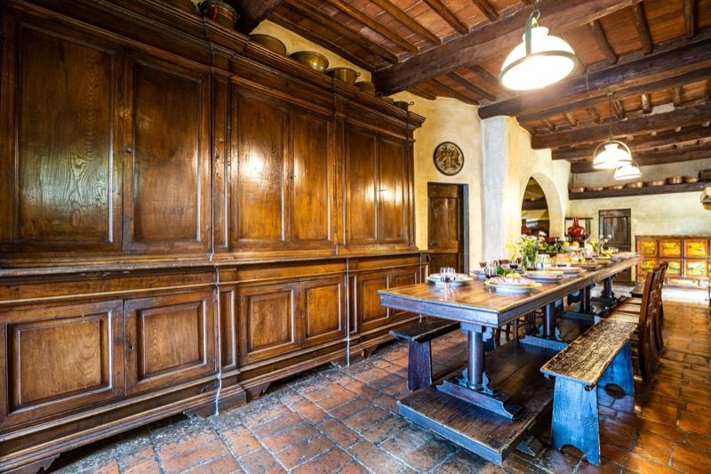The kitchen with wood panelling and the long table