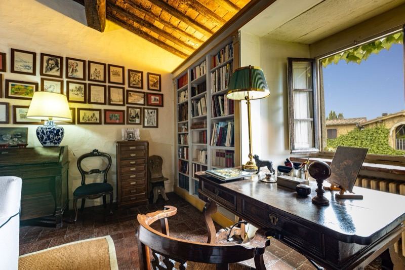 The study with bookshelves and the desk at the window