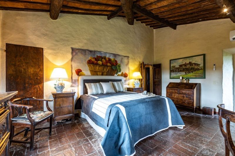 Bedroom with the fruit-basket painting and blue bedspread