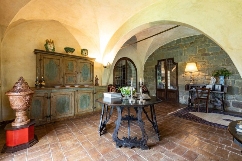 The painted cupboard and antique table in the vaulted hall