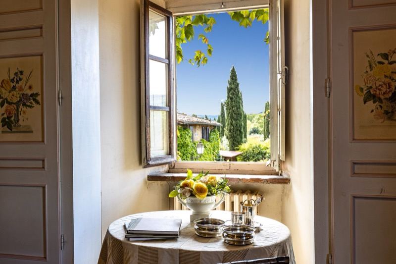 The window onto the villa and cypresses, with the fruit bowl