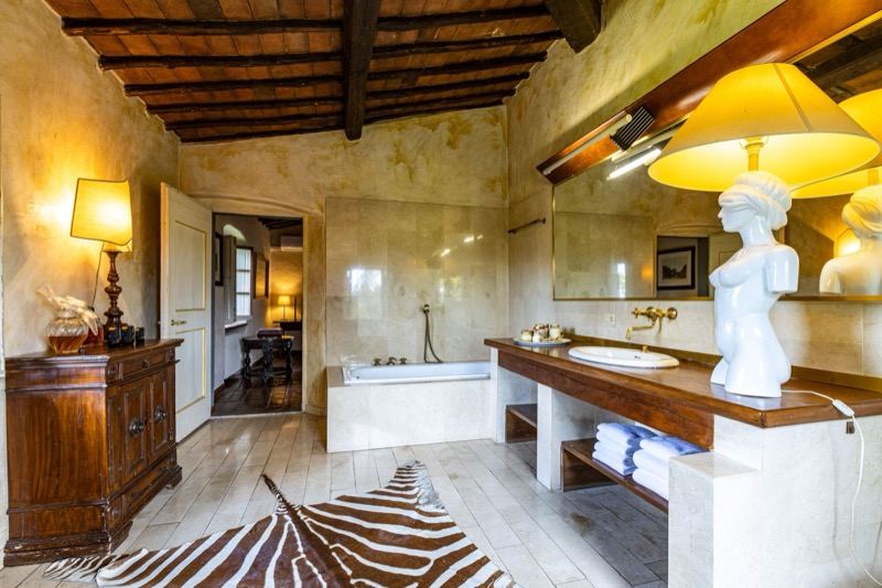 The bathroom with bathtub, statue and zebra rug