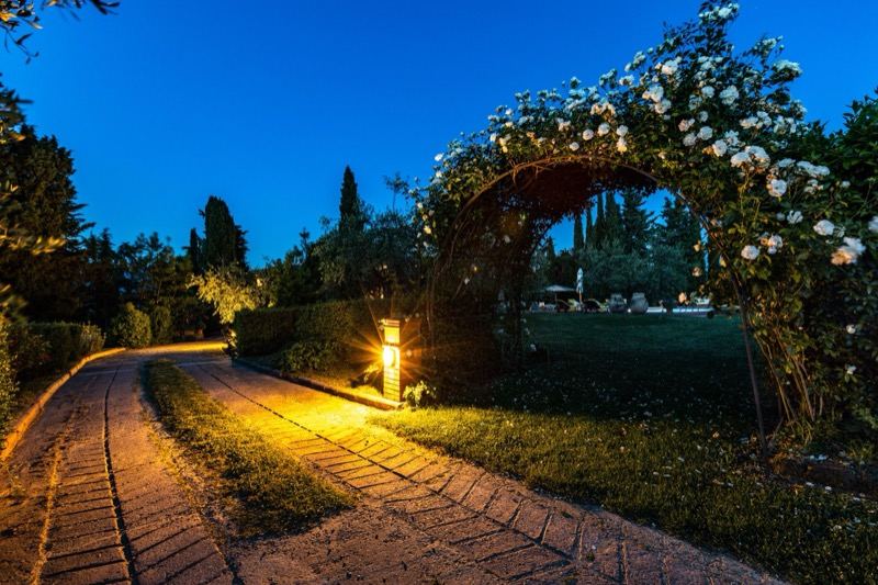 The rose arch and the lit path in the evening