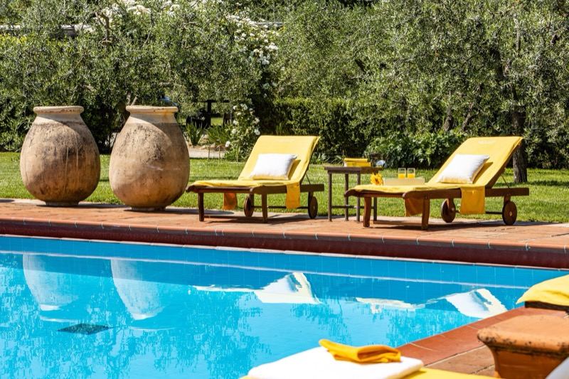 Terracotta jars and loungers by the pool