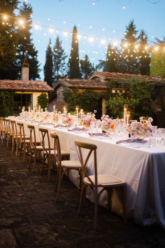 The white table in the courtyard under hanging lights