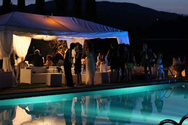 The white marquee and the poolside party at night