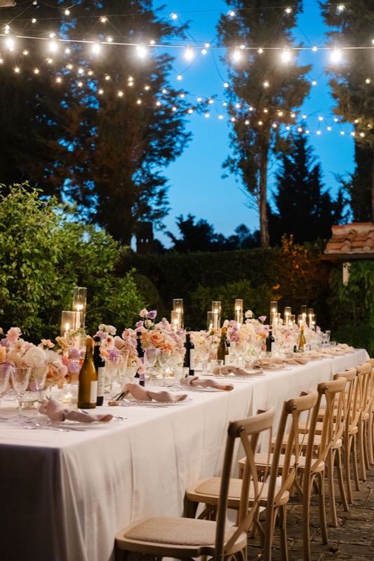 Evening table with candles under the lights in the blue hour