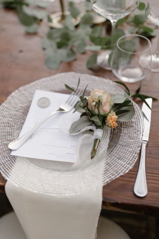 Place setting with menu card and flowers