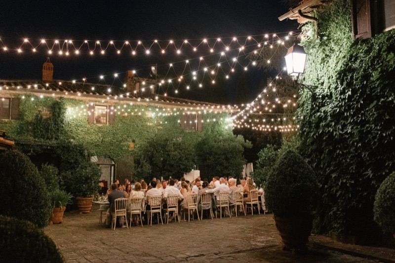 The courtyard dinner under hanging lights in the evening