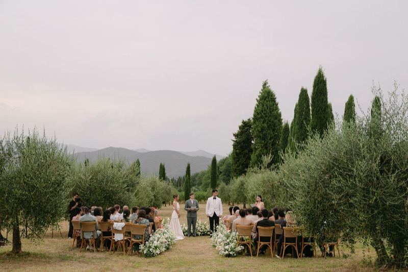 Ceremony among the olive trees with seated guests