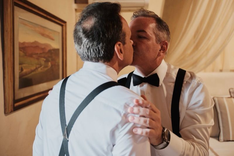 The grooms' kiss before the ceremony