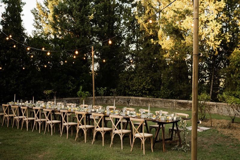 The long table under string lights in the garden