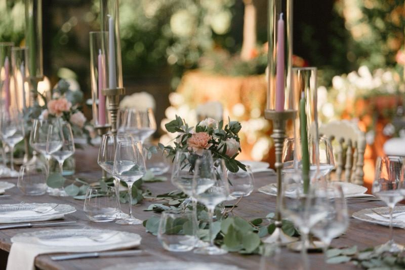 Candles, glasses and flowers on the table