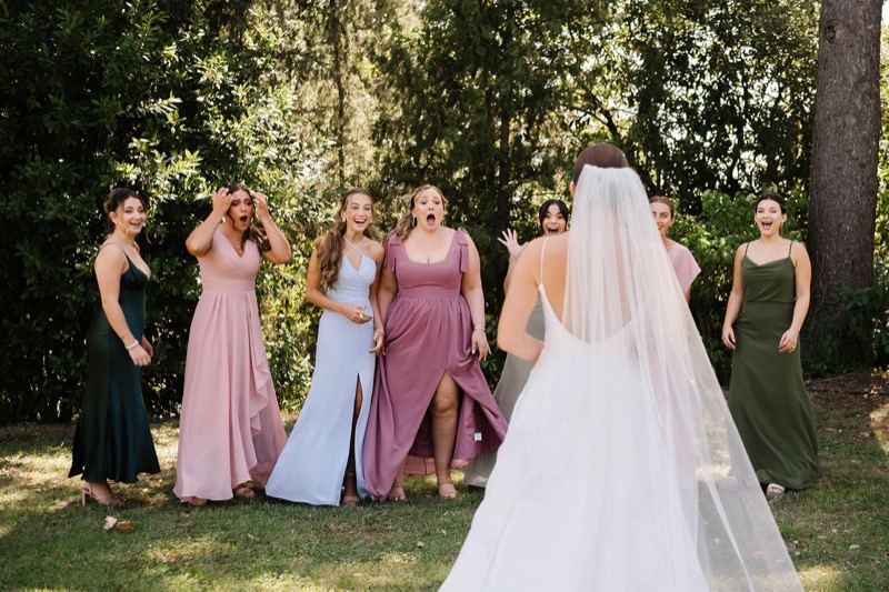 The bride with her bridesmaids in the garden