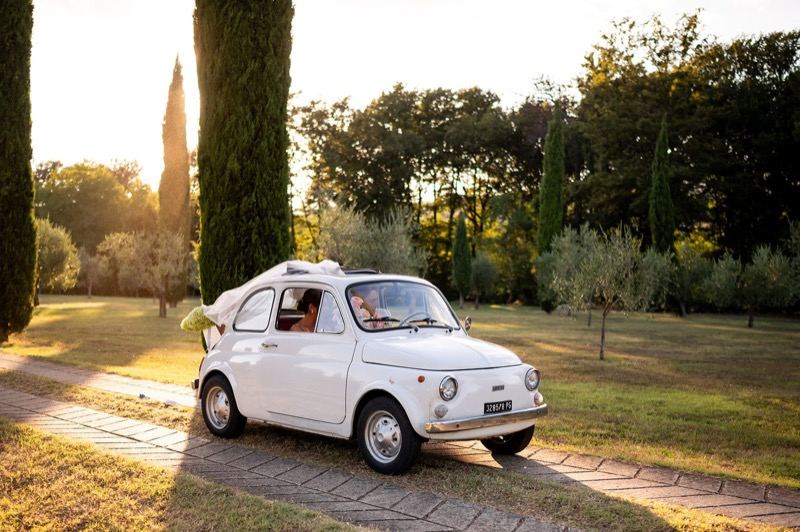 The couple's white Fiat 500 at sunset