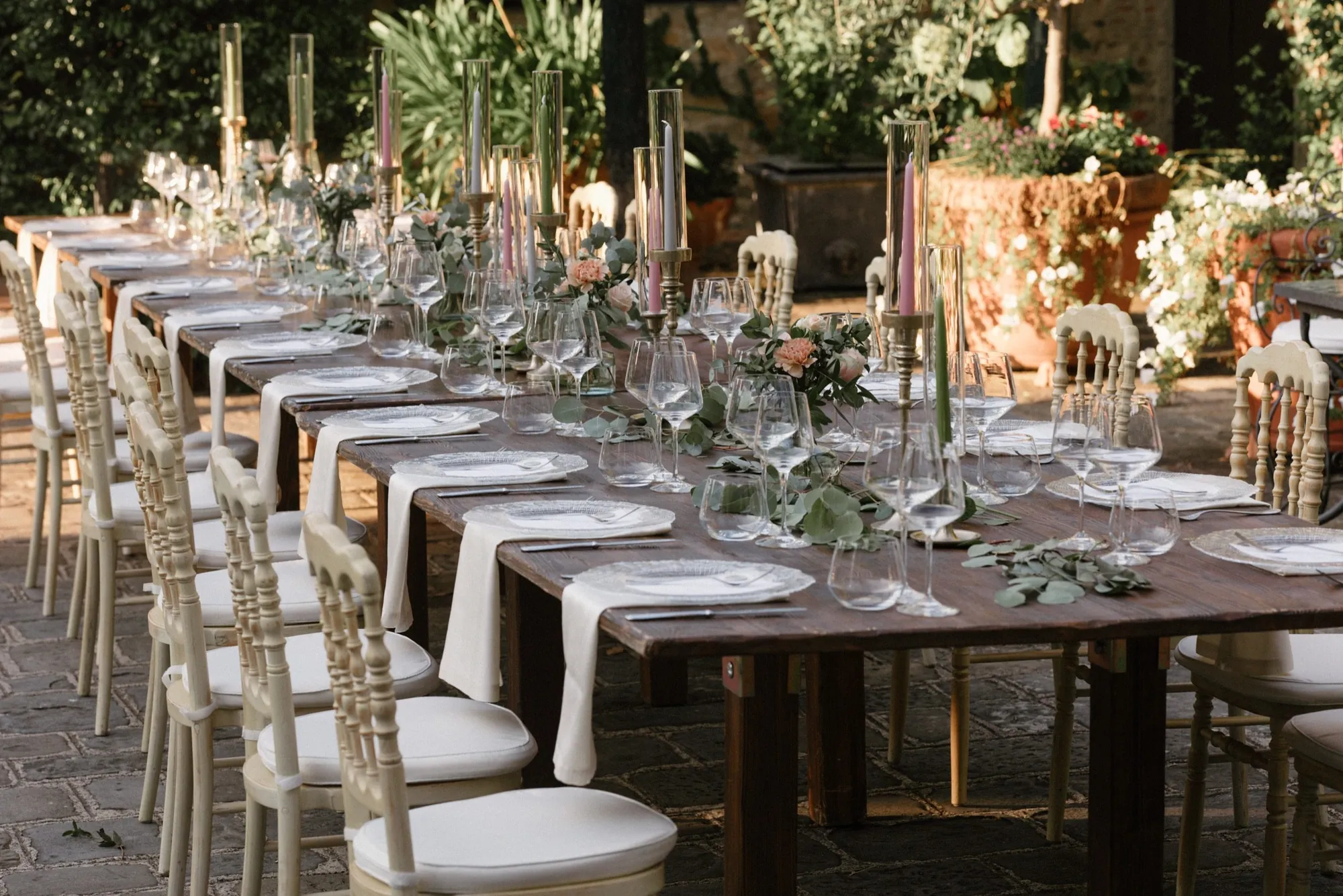 Long wedding table set for dinner at golden hour